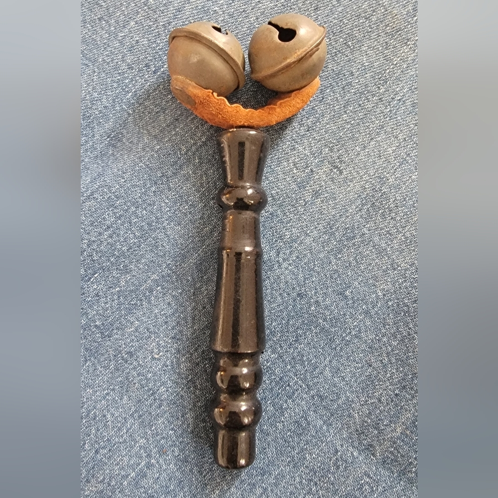 Antique black wood and leather baby rattle. Excellent condition. 2x5 inches.